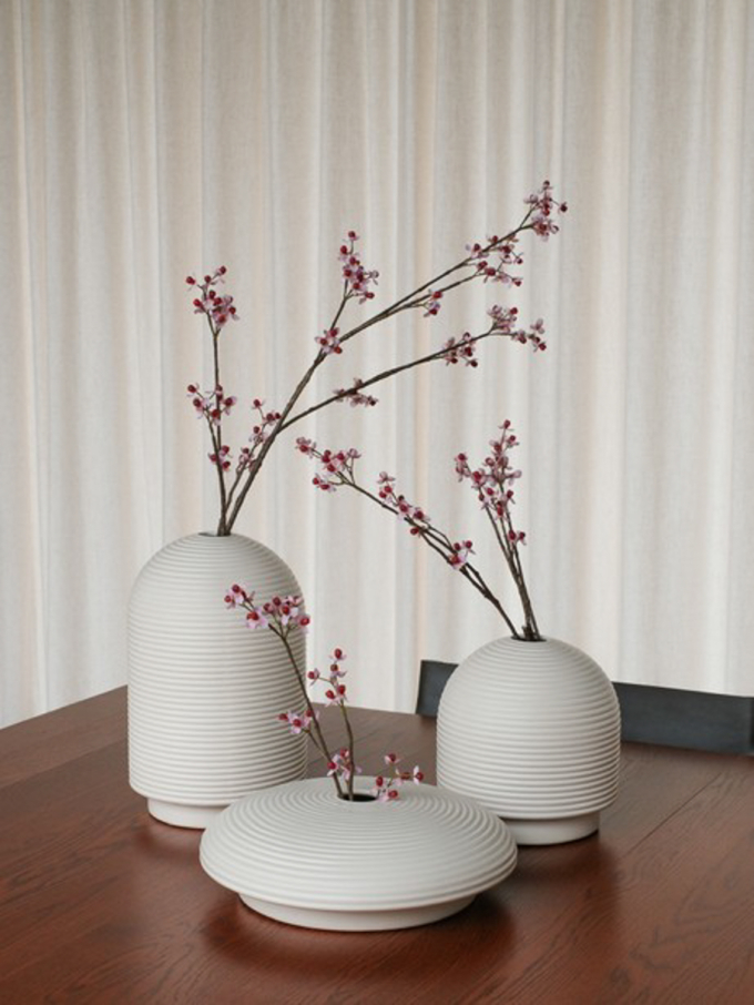 Table with ribbed vases in natural colors