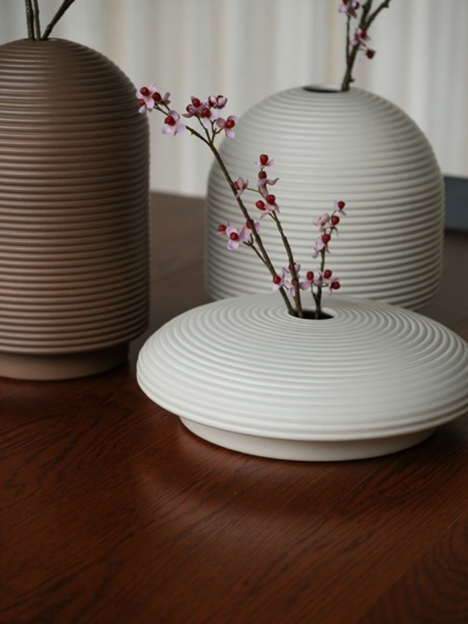 Table with ribbed vases in natural colors