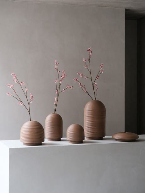 XLBoom Nova Vases in mocha finish in all shapes with pink blossom branches on minimalist pedestal