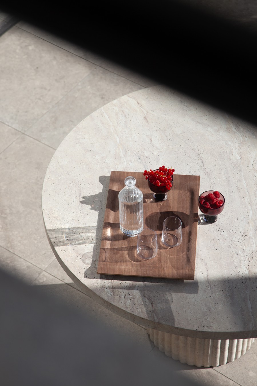 Flow walnut tray styled with glassware on a stone table